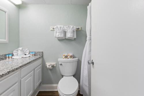 a bathroom with a toilet and a sink and a shower at SeaMist Driftwood Vacation Studio with Balcony in Myrtle Beach
