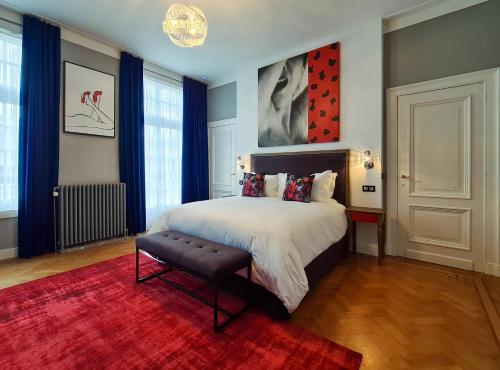 a bedroom with a bed and a red rug at The Old Beech in Antwerp