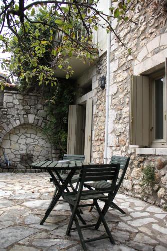 a picnic table in front of a stone building at The Stonehouse in Stemnitsa