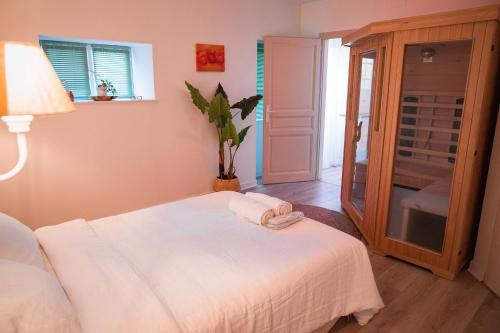 a bedroom with a bed with a towel on it at Slocations in Vandoeuvre-lès-Nancy