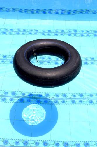 a black tire in a swimming pool at Bầu Bí Mini Farmstay Mekong - Tiền Giang in My Tho