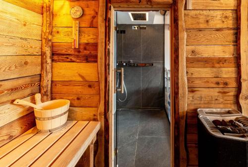 a bathroom with a shower in a wooden cabin at Chalet Cormignano in Vezza dʼOglio