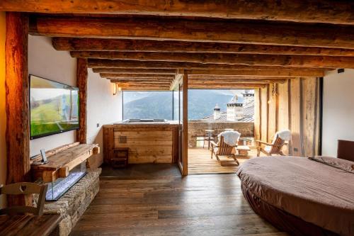 a bedroom with a bed and a sliding glass door at Chalet Cormignano in Vezza dʼOglio