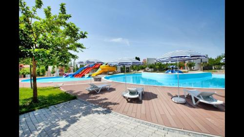 a swimming pool with chairs and umbrellas at Arena Hotel Sheki in Sheki