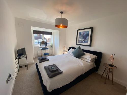a bedroom with a bed with a tray on it at Cliff Top Heights-Beach front house near Brighton in Rottingdean