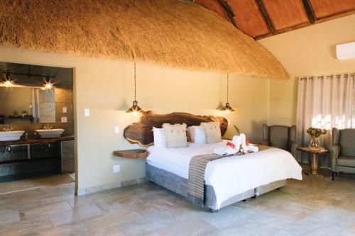 a bedroom with a large bed in a room at Kwadiwa Ranch in Baines Drift