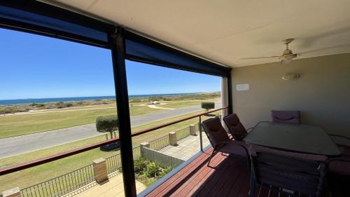 a room with a balcony with a table and chairs at Jaybay View in Jurien Bay