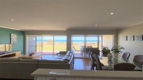 a living room with a couch and a table with chairs at Jaybay View in Jurien Bay