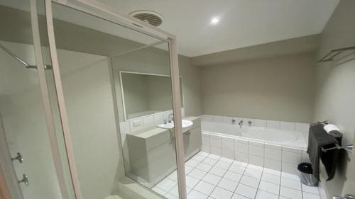 a bathroom with a shower and a tub and a sink at Jaybay View in Jurien Bay
