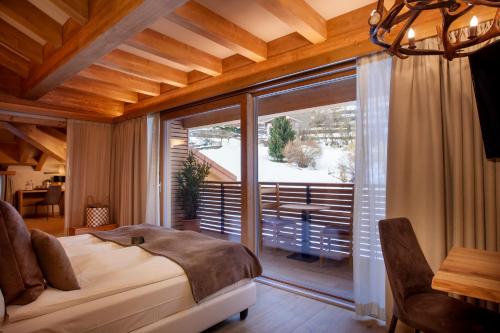 Ένα ή περισσότερα κρεβάτια σε δωμάτιο στο Boutique Hotel e Chalets Salvadori