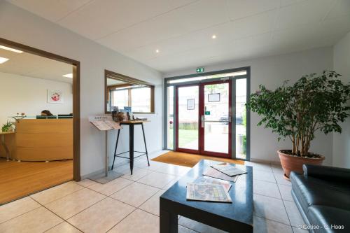 a living room with a couch and a table at Cerise Nantes La Beaujoire in Nantes