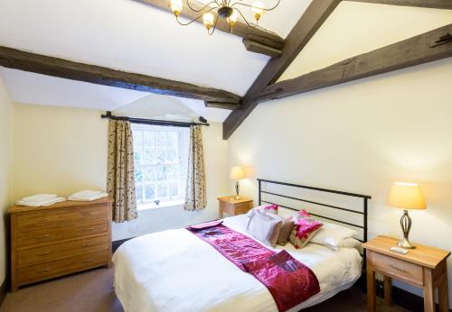 a bedroom with a large bed and a window at Badger Bar in Ambleside