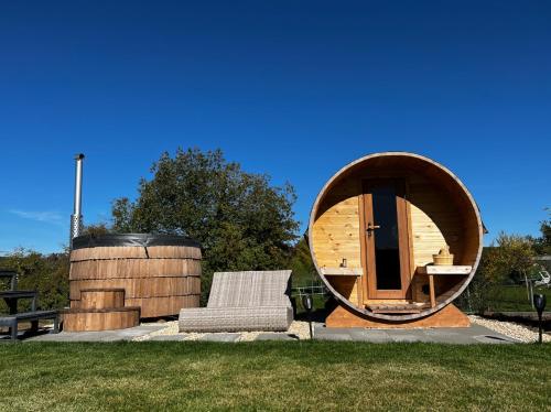 a circular house with a chair and a circular mirror at Tirolian Lodge South in Bundorf