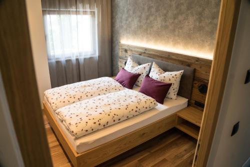 a bed with pillows on it in a room at Hilburgerhof in Schenna