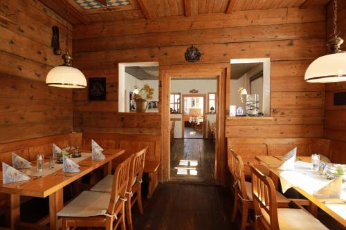 a dining room with wooden walls and tables and chairs at Weinstube Sinas Brettl in Nördlingen