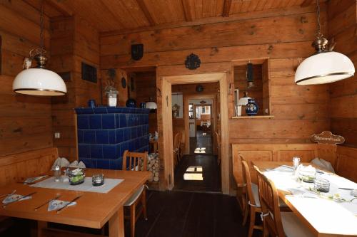a dining room with wooden walls and tables and chairs at Weinstube Sinas Brettl in Nördlingen
