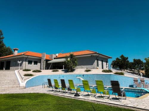 a group of chairs sitting next to a swimming pool at Maison familiale de caractère avec piscine in Padronelo