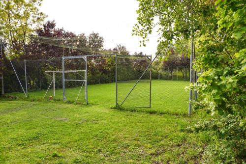 a soccer field with a net in the grass at Charming villa in Alvignano with private pool in Alvignano