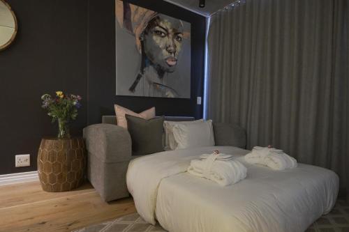 a bedroom with a large bed with towels on it at Urban Elephant. The Docklands in Cape Town