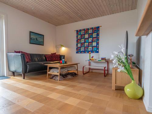 a living room with a couch and a table at Marna Guesthause doubleroom nr.1 in Tórshavn