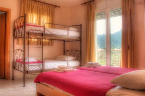 a bedroom with two bunk beds and a window at Studios Stella in Skala Potamias
