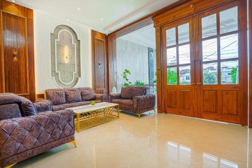 a living room with two couches and a table at Hotel Grand Cabbana By Levelup Hotels in Amritsar