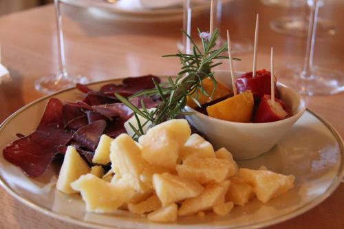a plate of food with fruit on a table at Boutique-Hotel Schlüssel in Beckenried