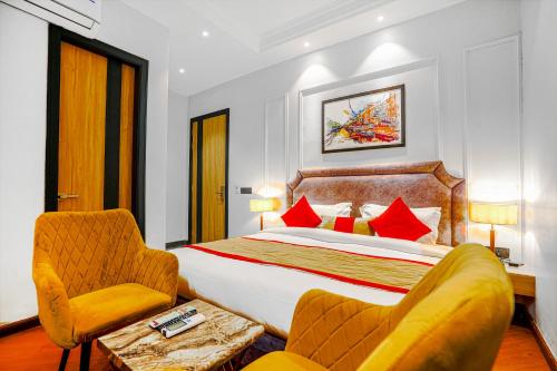 a hotel room with a bed and a chair at Hotel Grand Cabbana By Levelup Hotels in Amritsar