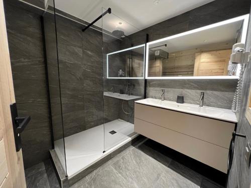 a bathroom with a sink and a shower at OURS POLAIRE bel appartement village et pistes in La Clusaz