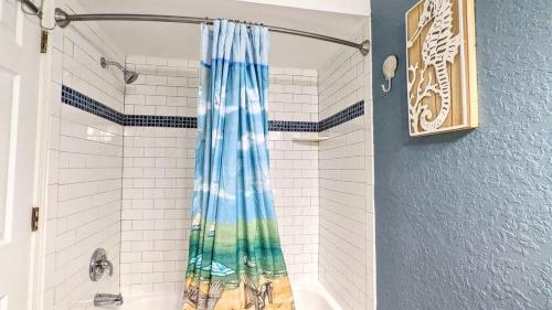 a bathroom with a shower with a shower curtain at Beach Escape by Casago in Saint Augustine Beach