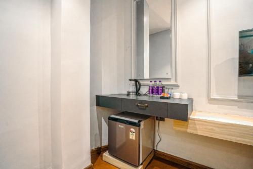 a bathroom with a sink and a trash can at Hotel Grand Cabbana By Levelup Hotels in Amritsar