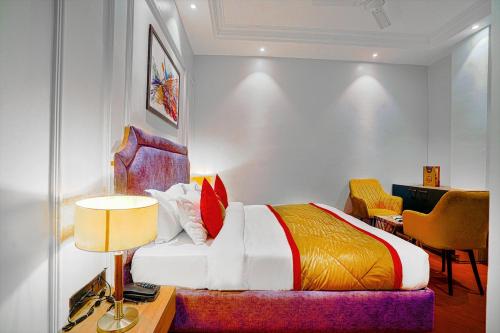 a bedroom with a bed and a desk and a chair at Hotel Grand Cabbana By Levelup Hotels in Amritsar