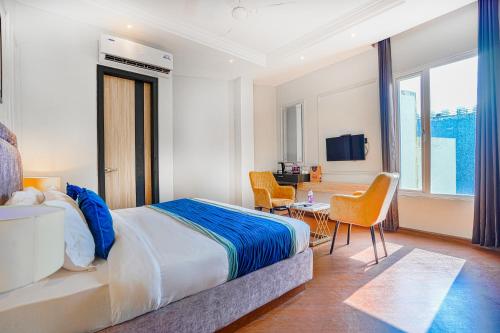 a hotel room with a bed and a table and chairs at Hotel Grand Cabbana By Levelup Hotels in Amritsar