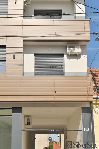 an external view of a building with an open garage at SilverSea Apartman in Šabac