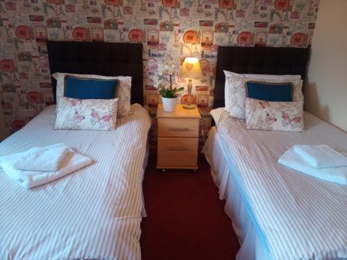 dos camas sentadas una al lado de la otra en una habitación en Fox and Hounds Country Inn en Willingham