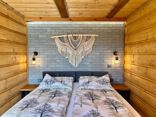 a bedroom with two beds and a chandelier at Dreamland in Bodzentyn
