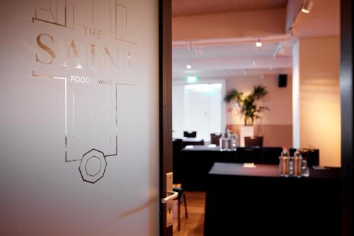 a door to a restaurant with a sign on it at Heavens Hotel in Hoorn