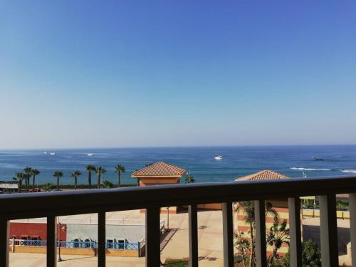 a view of the beach from the balcony of a resort at Private Chalets in Porto Sokhna Pyramids - Families Only in Ain Sokhna