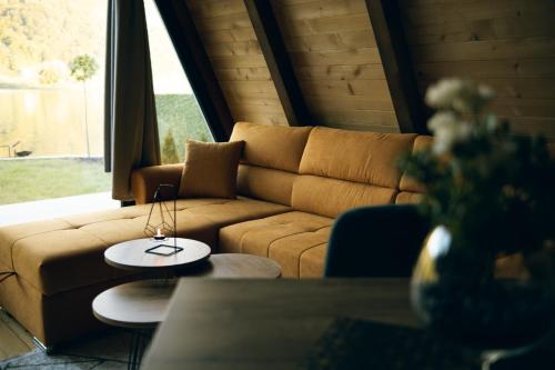 a living room with a couch and a table at Unique Lake House Paradiso in Zvornik