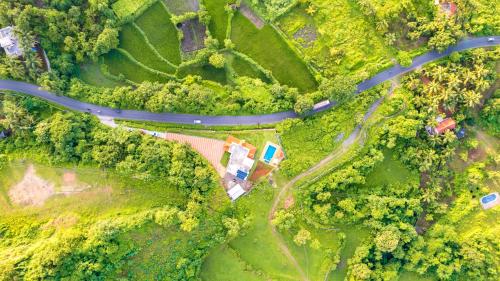 an aerial view of a road and a house in the forest at Spicy Mango Ocean Paradise - Luxurious Sea View Villa In Alibaug in Christpāda