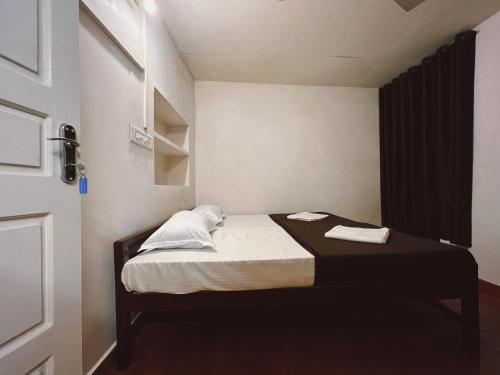 a small room with a small bed in it at Bunk house Fort Kochi in Cochin