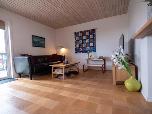 a living room with a couch and a table at Marna Luxus Guesthouse doubleroom nr.3 in Tórshavn