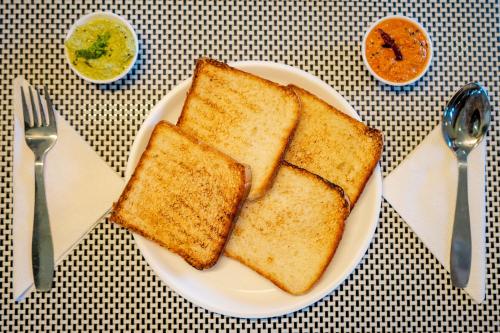 a plate with three slices of toast on a table at Spicy Mango Ocean Paradise - Luxurious Sea View Villa In Alibaug in Christpāda