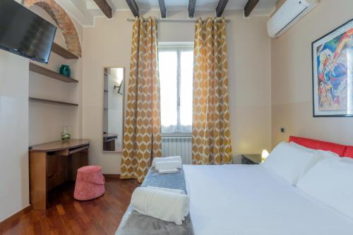 a bedroom with a bed and a desk and a window at Milan Retreats in Milan