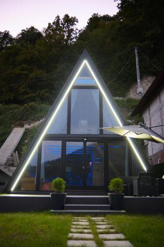 a house with a triangular roof with lights on it at Unique Lake House Paradiso in Zvornik