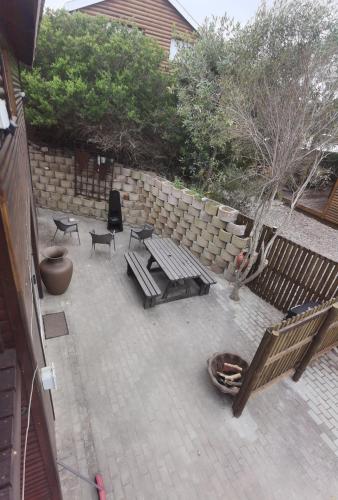 a patio with a bench and a table and chairs at Aurora's Rest 47 in Fisherhaven