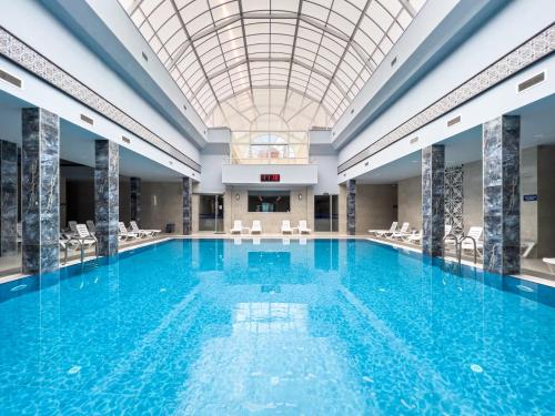 a large swimming pool with a glass ceiling at Spa Hotel Colossae Thermal in Pamukkale