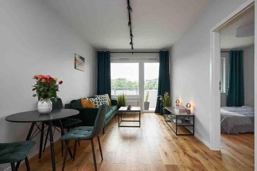 a living room with a table and a couch at Apartment Olympia in Wrocław