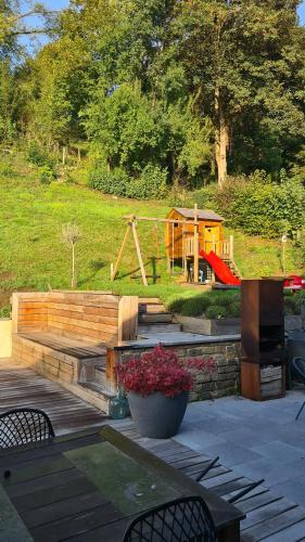 a backyard with a playground and a play house at Sol'Croupet in Theux