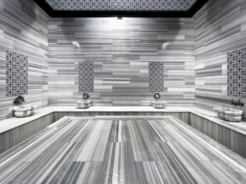 a bathroom with two sinks and ailed floor at Spa Hotel Colossae Thermal in Pamukkale